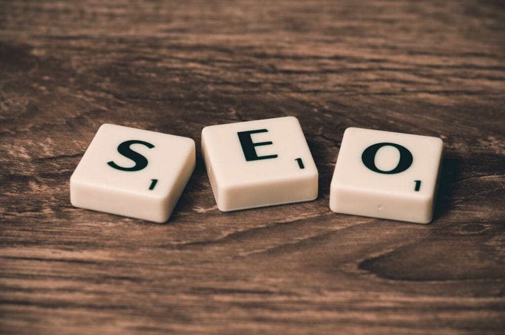 Wooden tiles spelling SEO, highlighting search engine optimization strategies integrated into our custom WordPress development services.