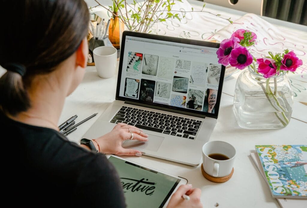 A person working on a laptop, illustrating the choice between Wix and custom WordPress development for growing businesses.