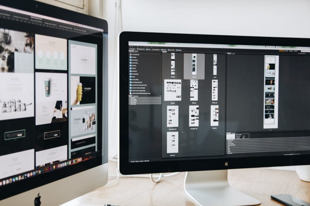 Desktop monitors displaying digital layouts, representing the Figma to WordPress conversion step in our custom WordPress development process.